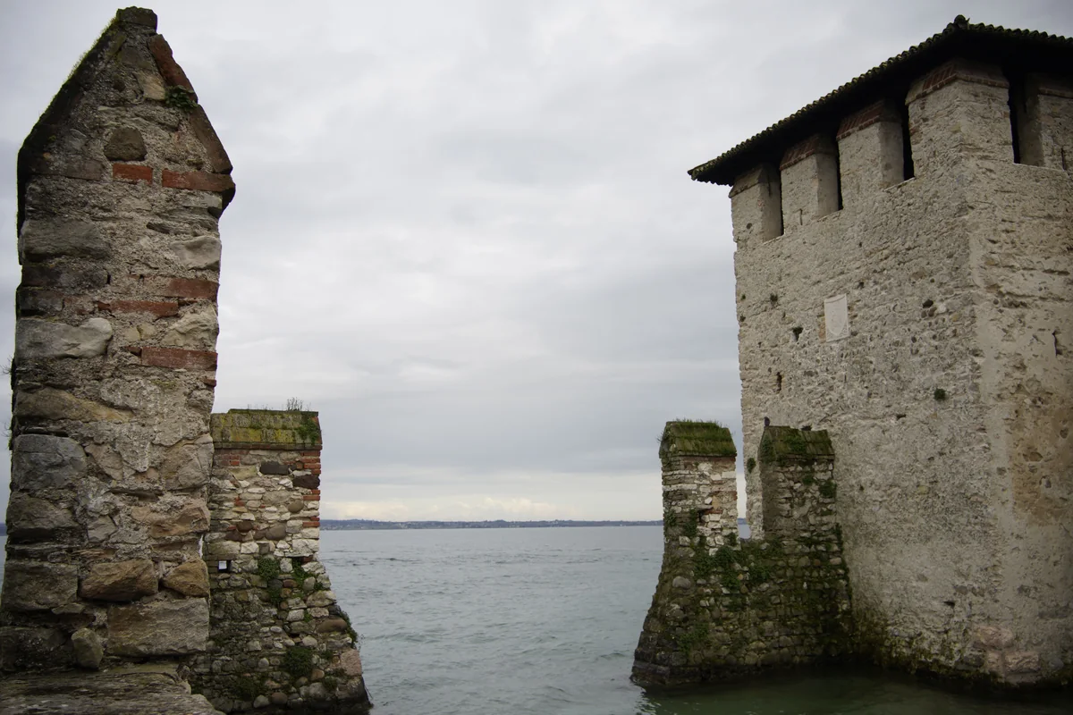 The stone towers of the Scaliger Castle seen from the water at Sirmione